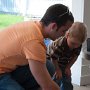 Uncle Mark teaching Daniel how to play with matchbox cars.